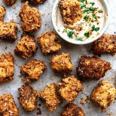 Cajun popcorn bites with creamy maple dip, using tofu instead of chicken as the plant-based substitution.