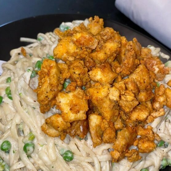 Vegetable Alfredo pasta using popcorn tofu instead of chicken for a plant-based meal.