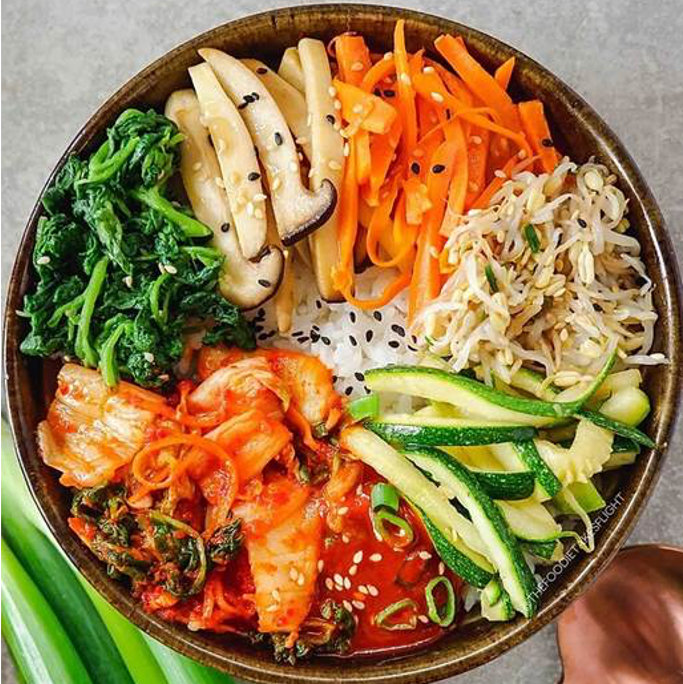 Korean BBQ vegan protein bowl loaded with seasoned vegetables and pickled cucumbers.