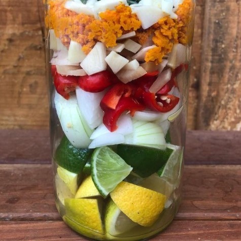 Fire cider made from lemon, lime, chilli, garlic, parsley, rosemary, thyme and oregano from the garden, plus fresh ginger, turmeric, onion, a few peppercorns and raw apple cider vinegar.