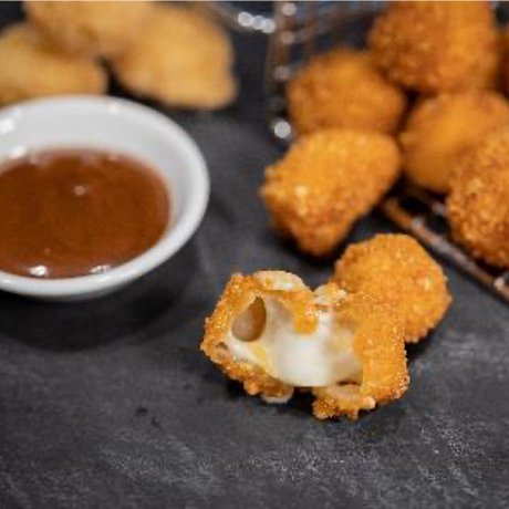 White cheese curds are coated in a crispy potato flake coater and finished with our Gravy Flavor Glaze.