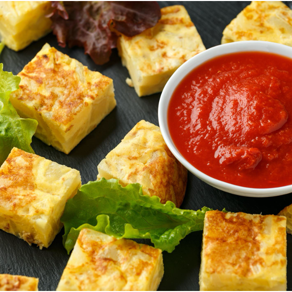 Poached eggs with a spicy tomato sauce featuring roasted red peppers and delicious Middle Eastern warming spices cooked into the eggs for a quick, delicious egg bite.