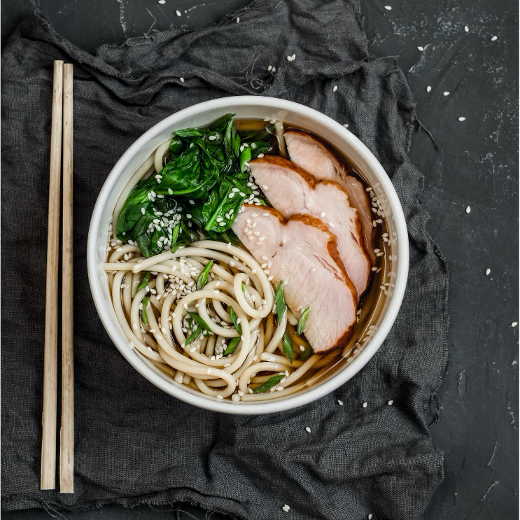 Sauteed sweet potato, broccoli, glass noodles, and bean sprouts are served in a soy ginger glaze and topped with crispy pork.