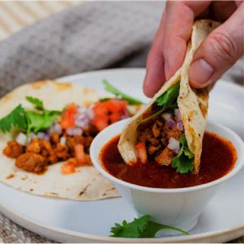 Birria chicken tacos elevate the comfort experience by pairing with a warm broth.