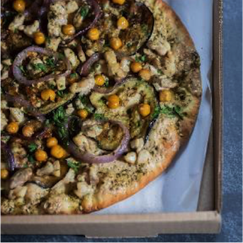 Pizza made with a garlic tahini sauce base, topped with chicken, veggies, chickpeas and finished with a Za’atar spice.