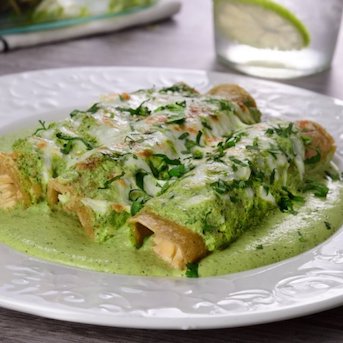 Tortilla filled with seasoned shredded chicken, topped with poblano sauce and a mix of cheeses.