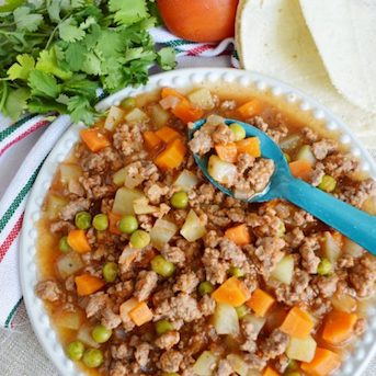Picadillo made with seasoned meat, vegetables, and tomato sauce.