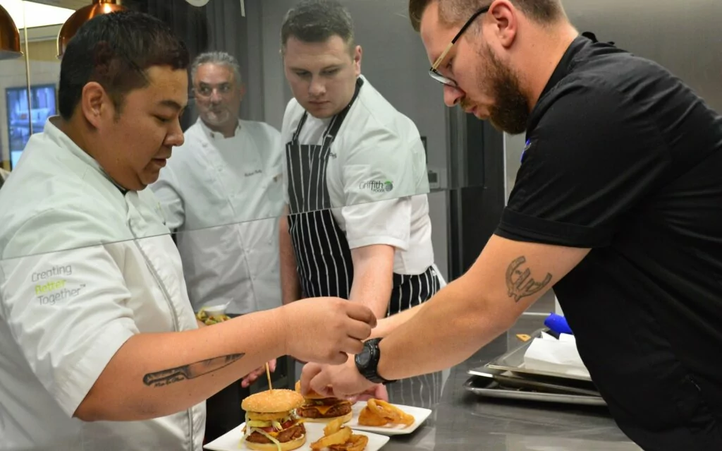 Griffith Food chefs putting the finishing touches on a burger dish that came from our FlavorIQ process.