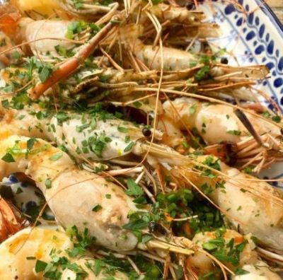 Grilled Langoustines with garlic, fine herbs, and butter.