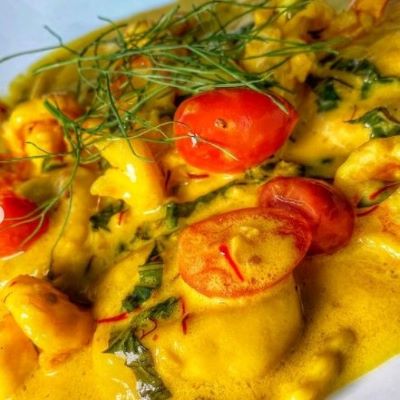 Lobster ravioli served with a creamy garlic saffron sauce and shrimp.
