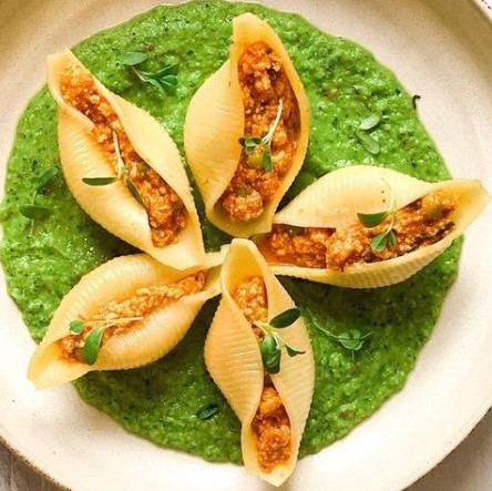 Paneer stuffed shell pasta with cumin and tumeric served over a mint-pea sauce
