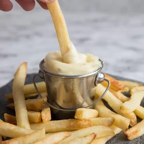 Home-style fries dipped in roasted garlic aioli