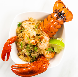 Lobster stuffed with garlicky rice and shrimp and green garnish