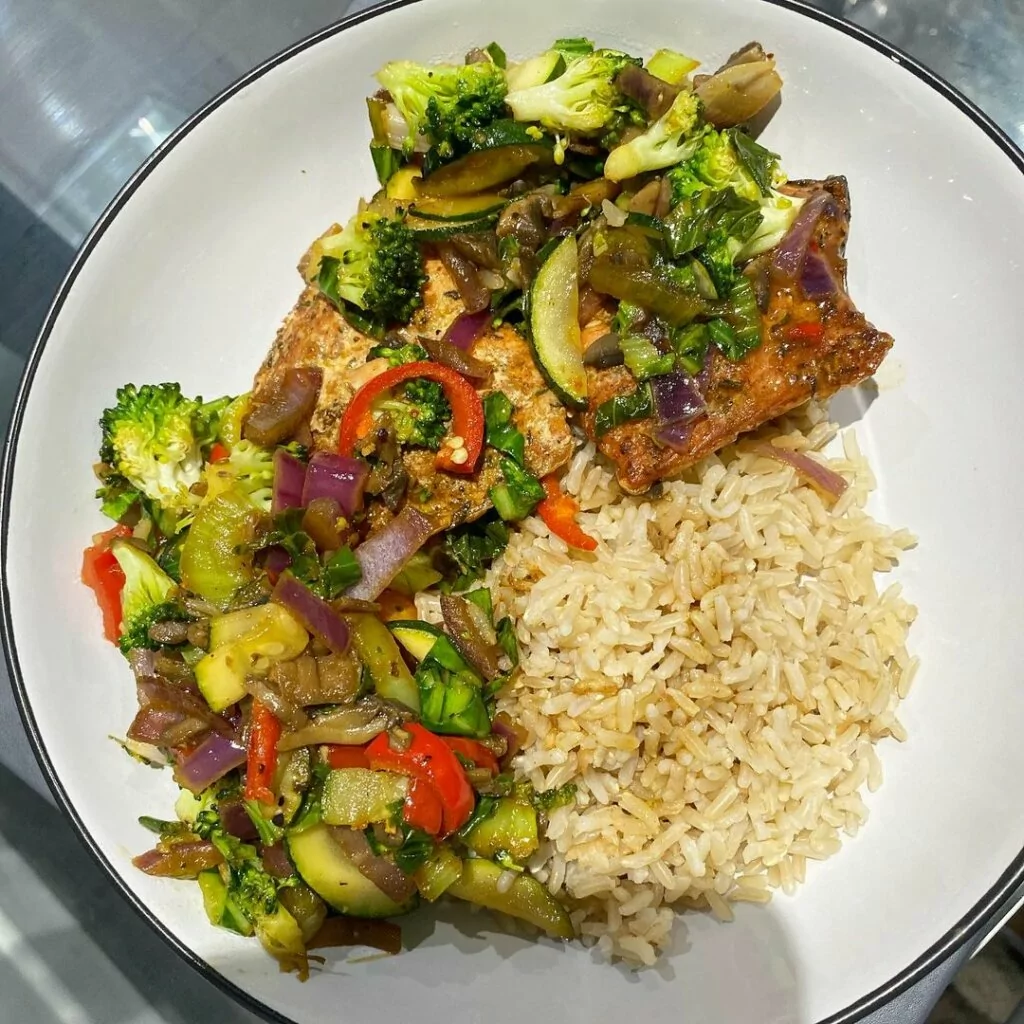 Spiced salmon, brown rice and vegetables cooked in garlic oil and a gluten free soy sauce