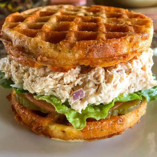 Chicken salad sandwich on a waffle made from cheese and eggs for a low-carb sandwich,
