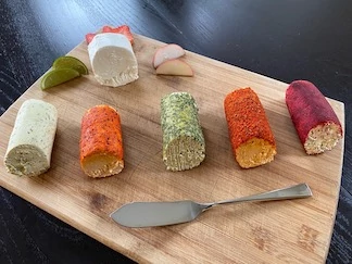 Goat cheese rolled in trendy seasonings and topicals.