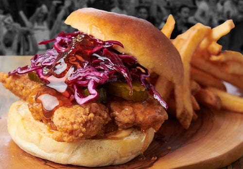 Firkin Pub's Wicked Hot and Honey Fried Chicken Sandwich with a side of fries.