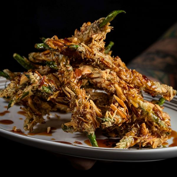 Green beans crusted with almonds bring a crunch to the dish without using bread crumbs.