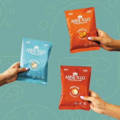 3 hands holding different flavors of Arise N' Go Popped Water Lilly Seeds